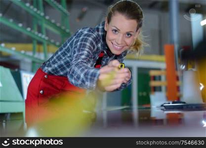woman measuring factory object