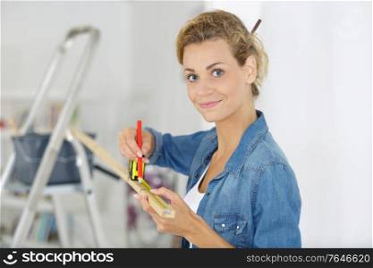 woman measuring furniture with tape measure