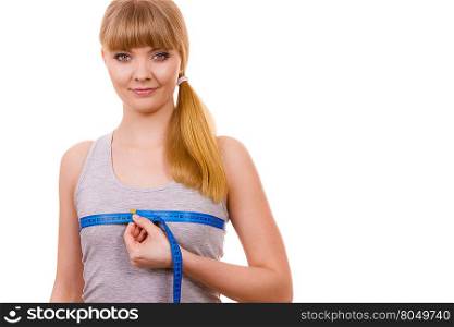 woman measuring her chest breasts isolated. Fitness woman fit girl with measure tape measuring her chest breasts isolated on white