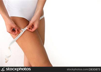 Woman measuring her thighs