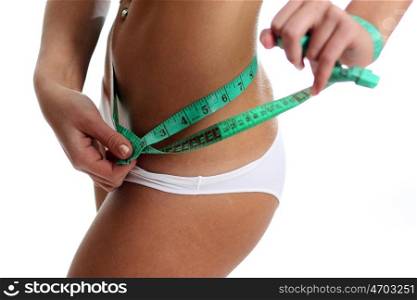 Woman measuring perfect shape of beautiful thigh