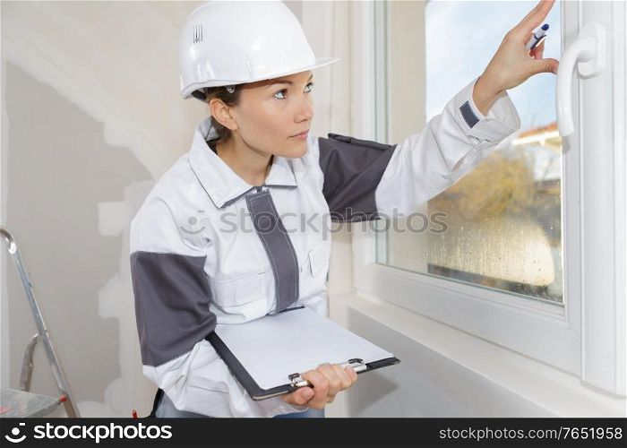 woman measuring the wall with tape measure