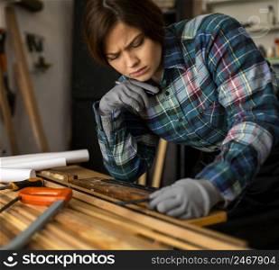 woman measuring wood planks 2