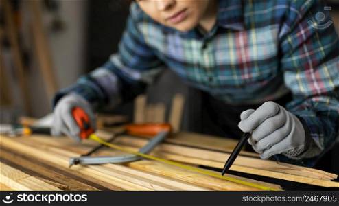 woman measuring wood planks