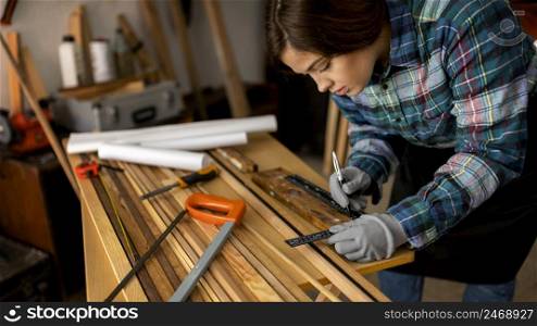 woman measuring wood planks 3