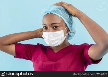 woman medic wearing surgeon mask