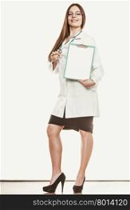 Woman medical doctor with stethoscope, clipboard and pen wearing white coat. Professional health care advertisement.