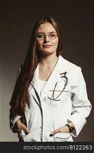 Woman medical doctor with stethoscope wearing white coat in studio on black. Professional health care.. Woman medical doctor with stethoscope. Health care