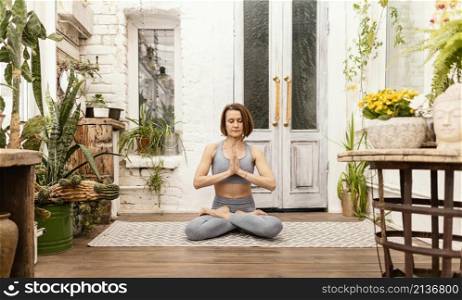 woman meditates indoors