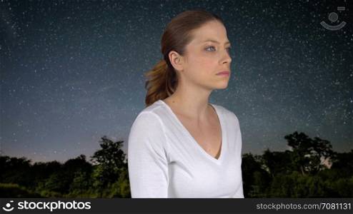 Woman meditates or prays at night