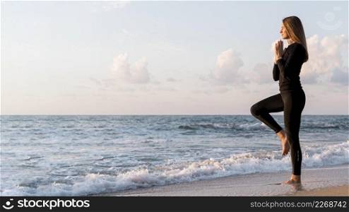 woman meditating beach with©space
