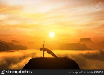 Woman meditating in side balance yoga position on the top of mountains above clouds at sunset. Zen, meditation, peace