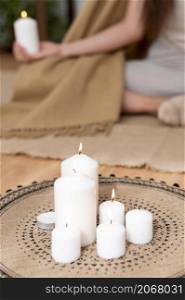 woman meditating with tray with candles