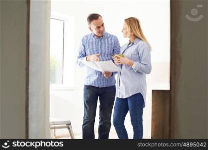 Woman Meeting With Architect Or Builder In Rennovated Property
