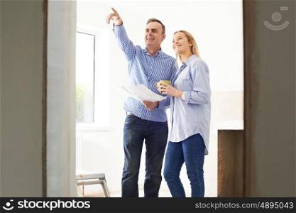 Woman Meeting With Architect Or Builder In Rennovated Property