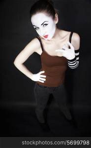 woman mime in white gloves on black background