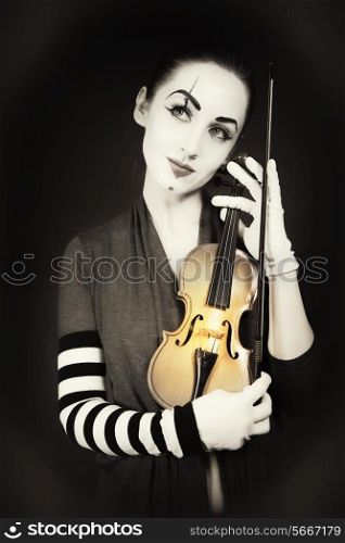 woman mime playing the violin. vintage