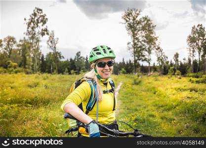 Woman mountain biker looking at camera smiling, Augsburg, Bavaria, Germany