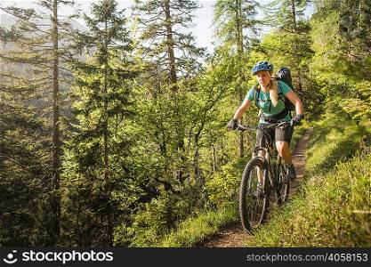 Woman mountain biking, Leermoos, Tyrol, Austria