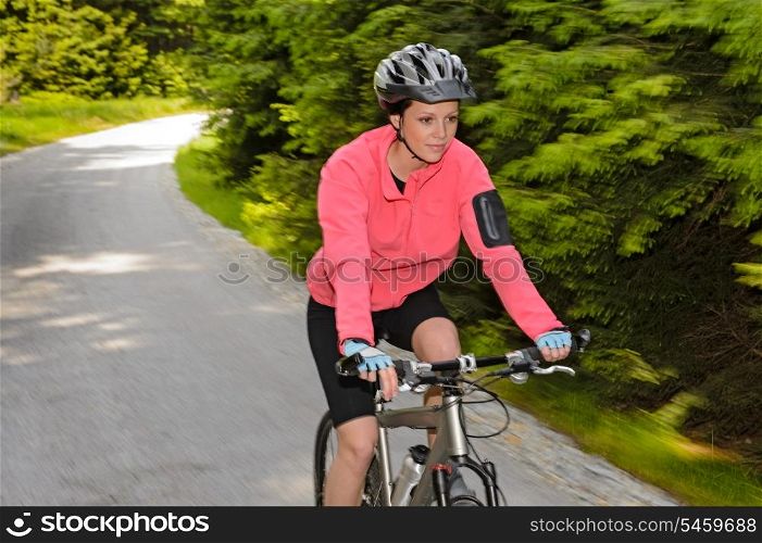 Woman mountain biking motion blur cycling path training race
