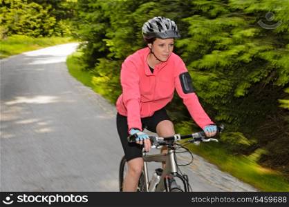 Woman mountain biking motion blur cycling path training race