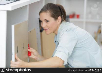 woman moving into new apartment house assembling