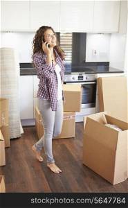 Woman Moving Into New Home Talking On Mobile Phone