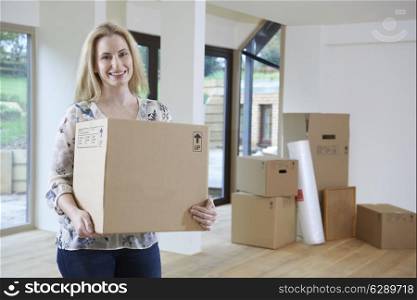 Woman Moving Into New Home With Packing Box