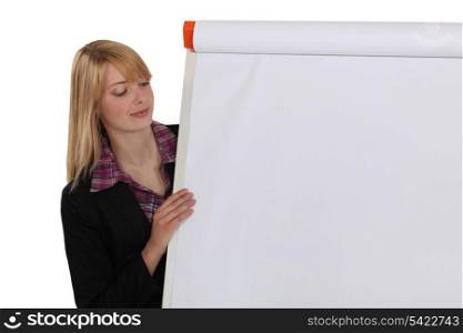 Woman near a paper board