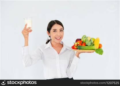 Woman nutritionist presenting diet food of fruit and vegetables for cholesterol control showing awareness and prevention of heart disease. Healthy eating and good nutrition concept.