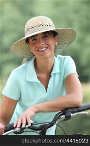Woman on a bicycle wearing a hat