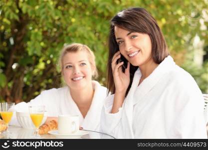Woman on a mobile phone at breakfast