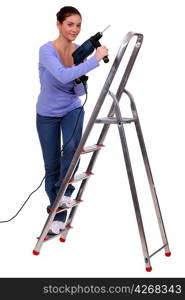 Woman on a stepladder with a powerdrill