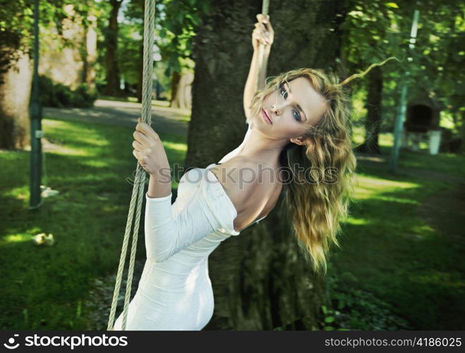 Woman on a tree swing.
