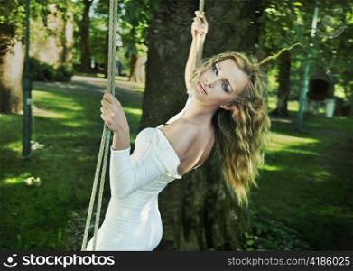 Woman on a tree swing.