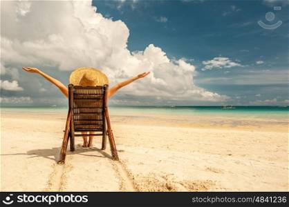 Woman on a tropical beach with hat, Boracay, Philippines.