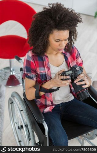 woman on a wheelchair looking image in the camera