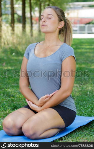 woman on a yoga mat to relax outdoors