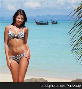 Woman on beach in Thailand. Beautiful woman in bikini on beach in Thailand