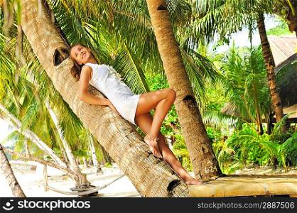 Woman on beautiful beach with palm trees at Philippines