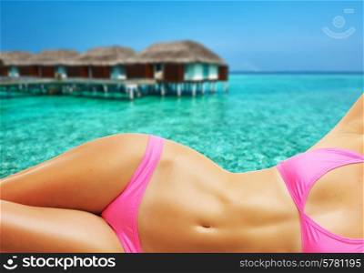 Woman on beautiful beach with water bungalows at Maldives. Collage.