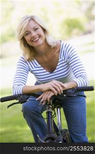 Woman on bike outdoors smiling