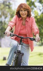 Woman on bike outdoors smiling