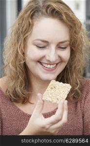 Woman On Diet Eating Crispbread At Home