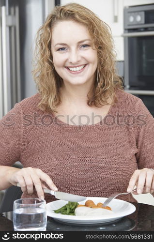 Woman On Diet Eating Healthy Meal In Kitchen