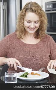 Woman On Diet Eating Healthy Meal In Kitchen