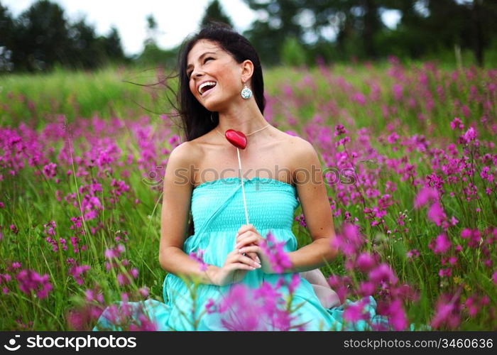 woman on flower field heart in hands