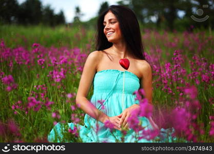 woman on flower field heart in hands