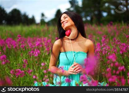 woman on flower field heart in hands