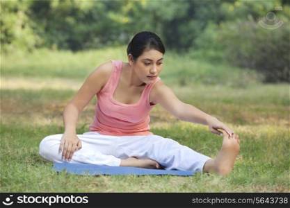 Woman on grass stretching